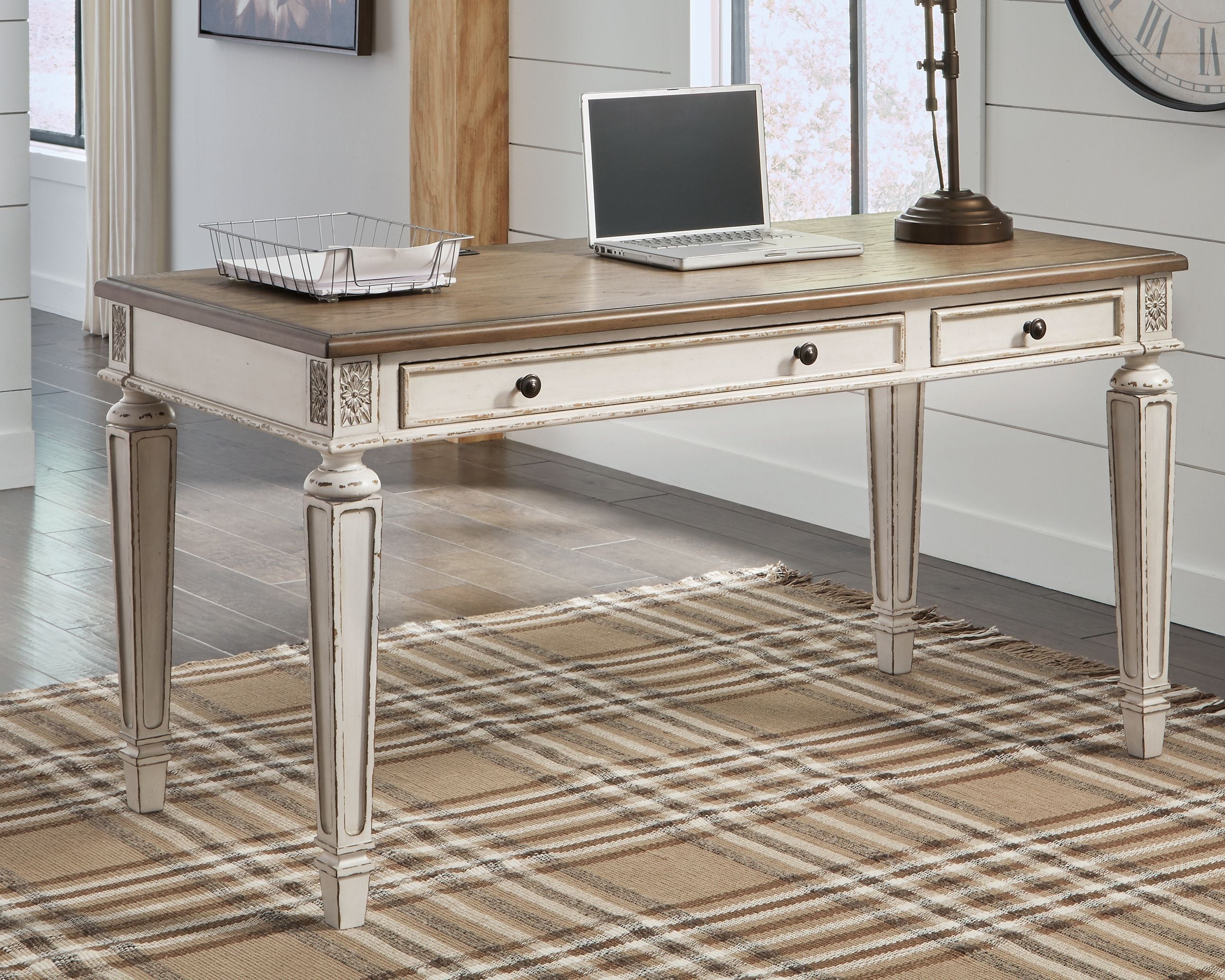 Light brown desk with two drawers and white turned legs, decorative apron