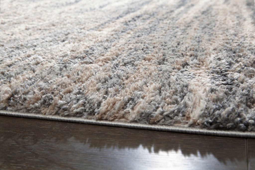 Textured shag rug with mixed gray and beige fibers along the edge