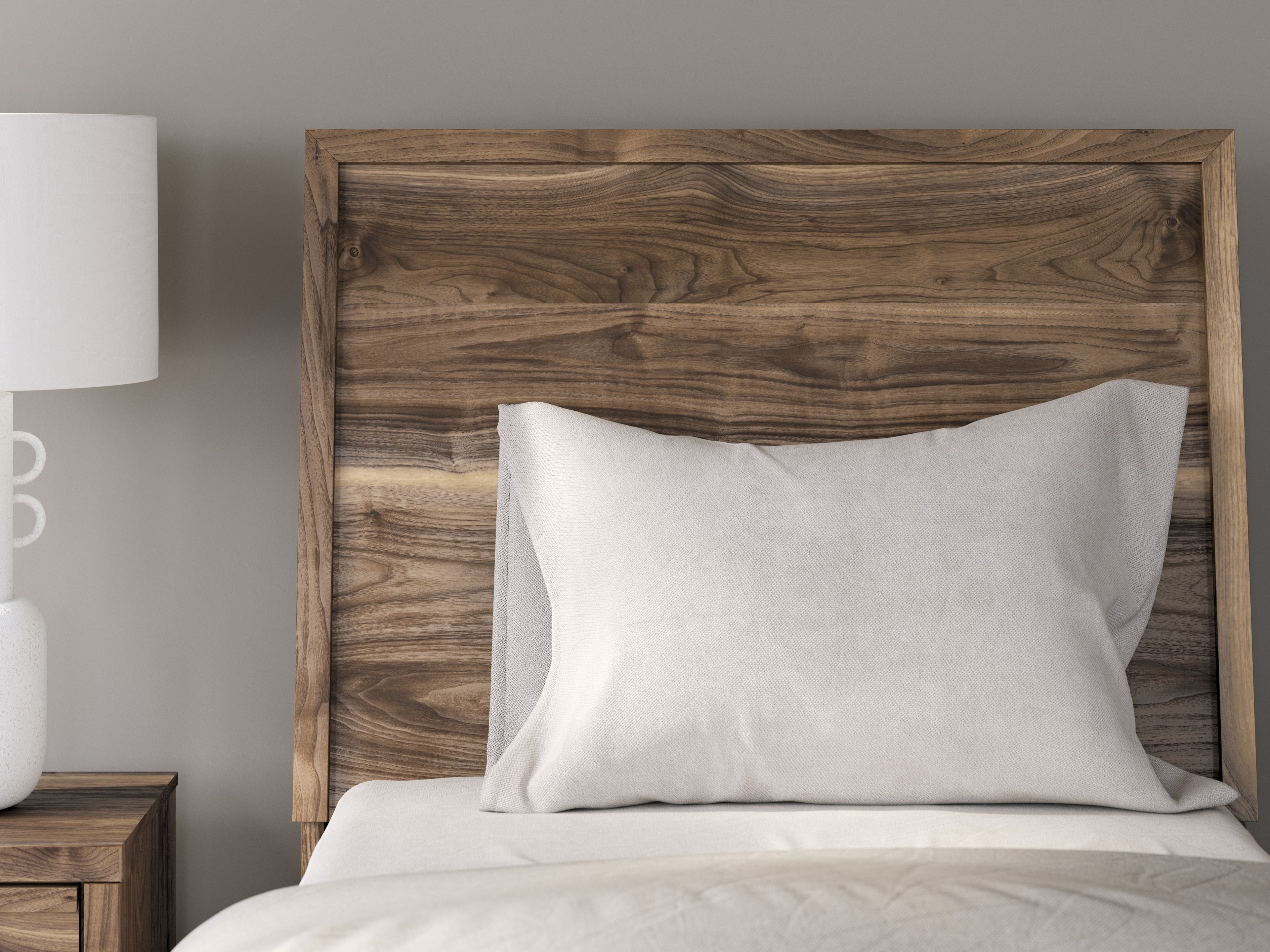 Dark brown panel headboard with bed pillows and white bedding