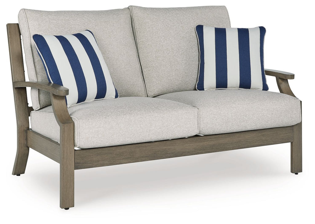Loveseat with cushion, light gray fabric and two blue striped pillows on brown frame