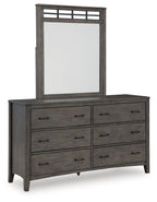 Grayish brown dresser with rectangular mirror over six drawers and metal pulls