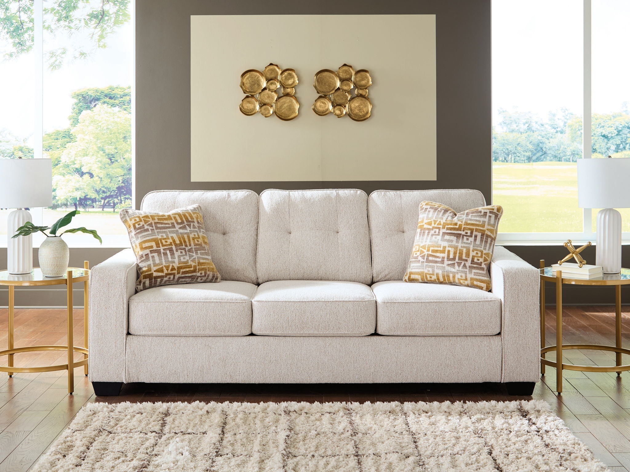 Larimer sofa in beige fabric with three seat cushions and two patterned throw pillows