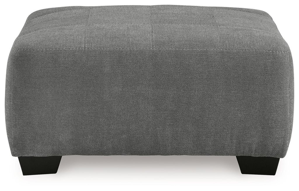 Gray upholstered accent ottoman, rectangular profile with black feet