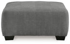 Gray upholstered accent ottoman, rectangular profile with black feet