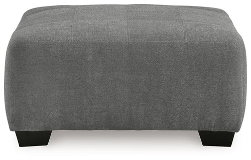 Gray upholstered accent ottoman, rectangular profile with black feet