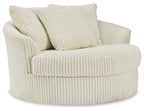Beige oversized swivel accent chair in ribbed corduroy with three back pillows