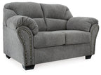 Pewter gray loveseat side view with padded roll arms and studded trim