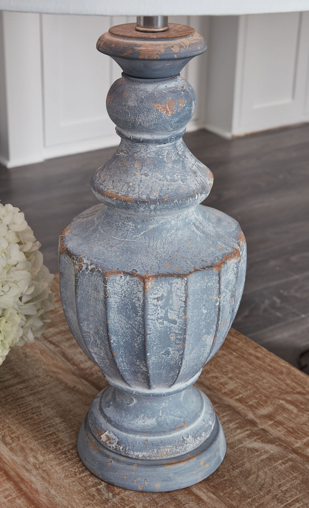 Antique blue table lamp base with worn rust accents and white fabric shade