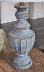 Antique blue table lamp base with worn rust accents and white fabric shade