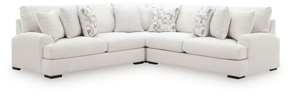 Light beige sectional sofa with two chaise sections and patterned accent pillows