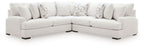 Light beige sectional sofa with two chaise sections and patterned accent pillows