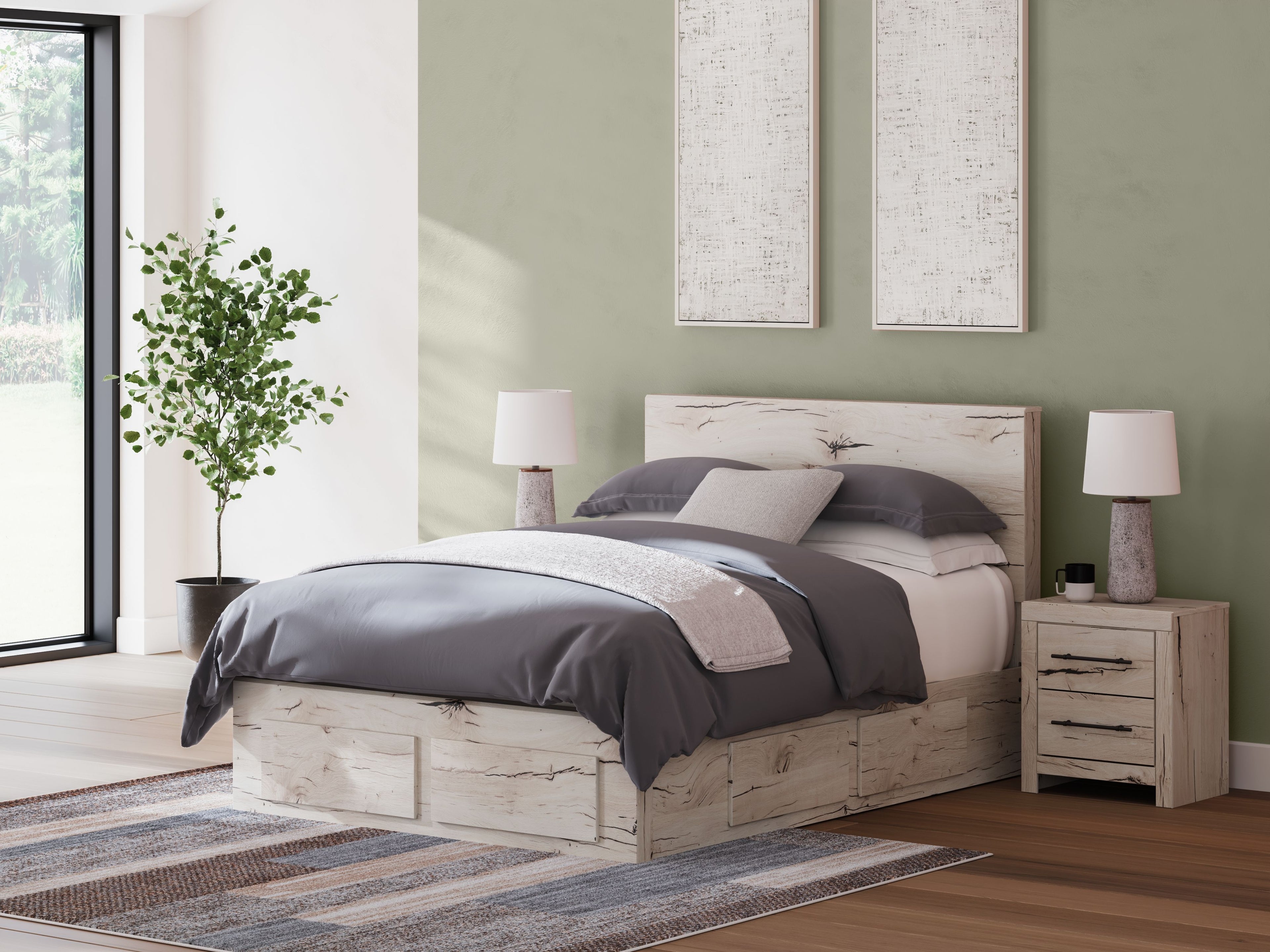 Light wood panel bed with storage drawers and gray bedding, side view