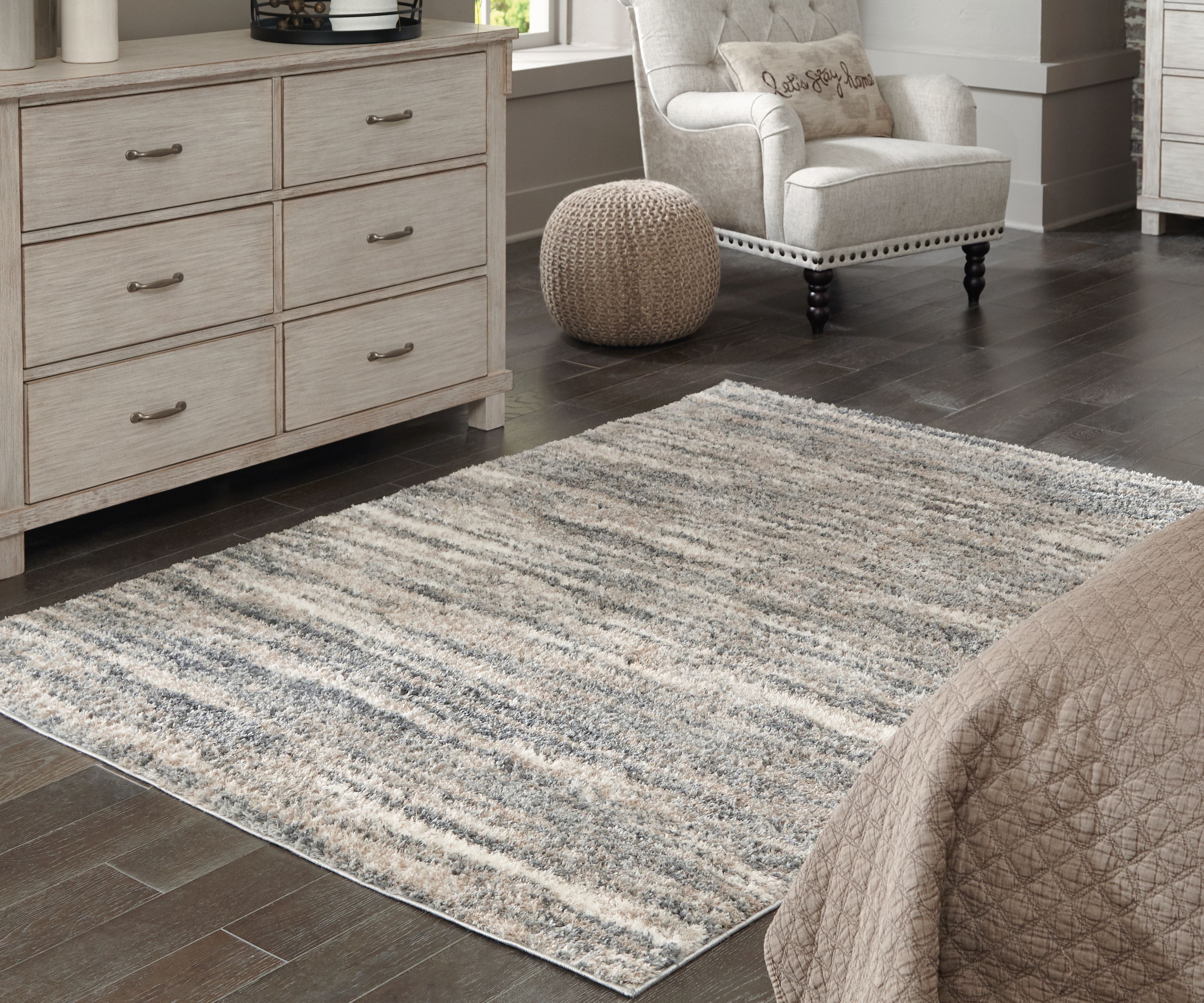 Beige and gray area rug with subtle striped pattern and thick pile