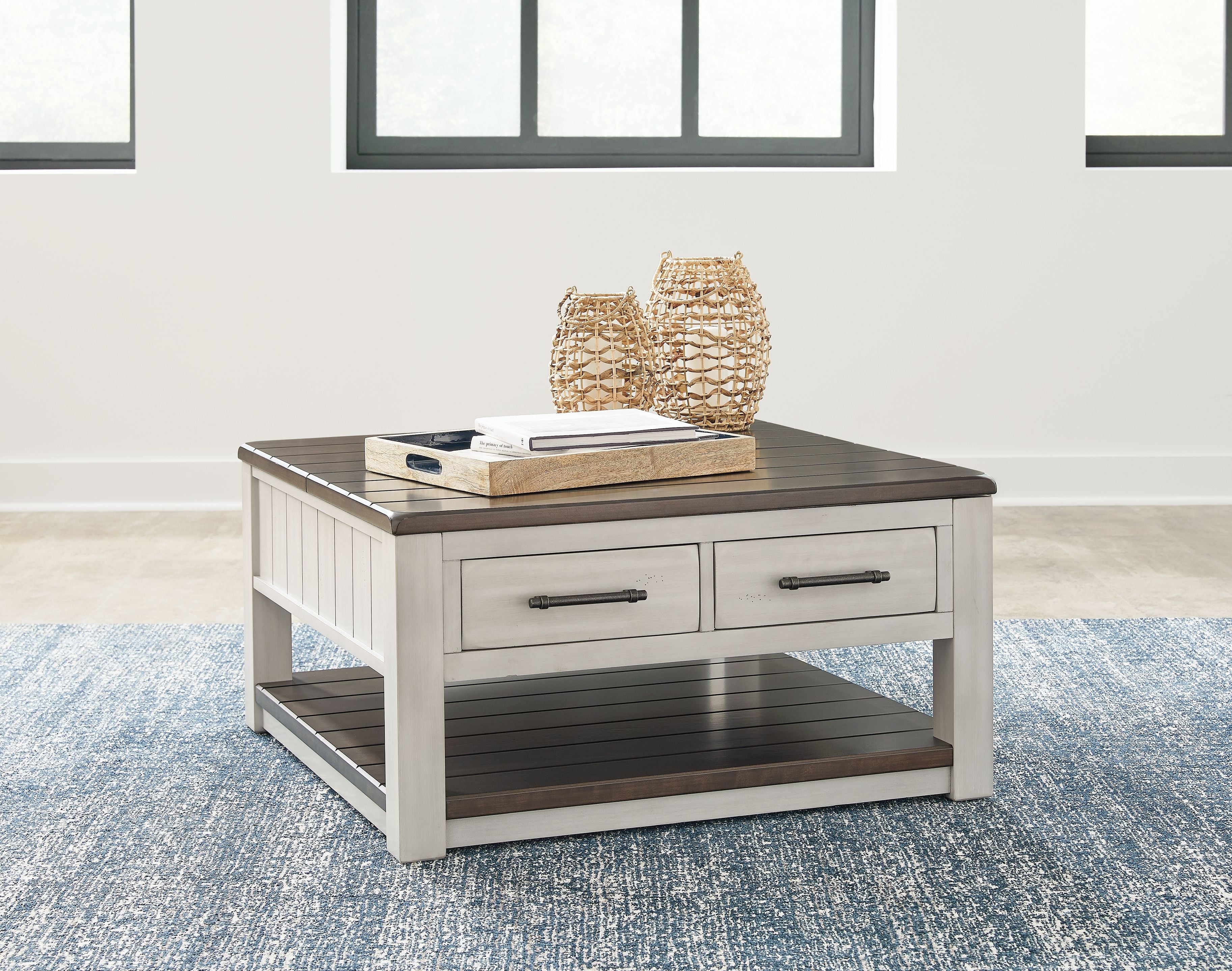 Lift-top cocktail table with gray finish, two drawers, dark slatted shelf, open top