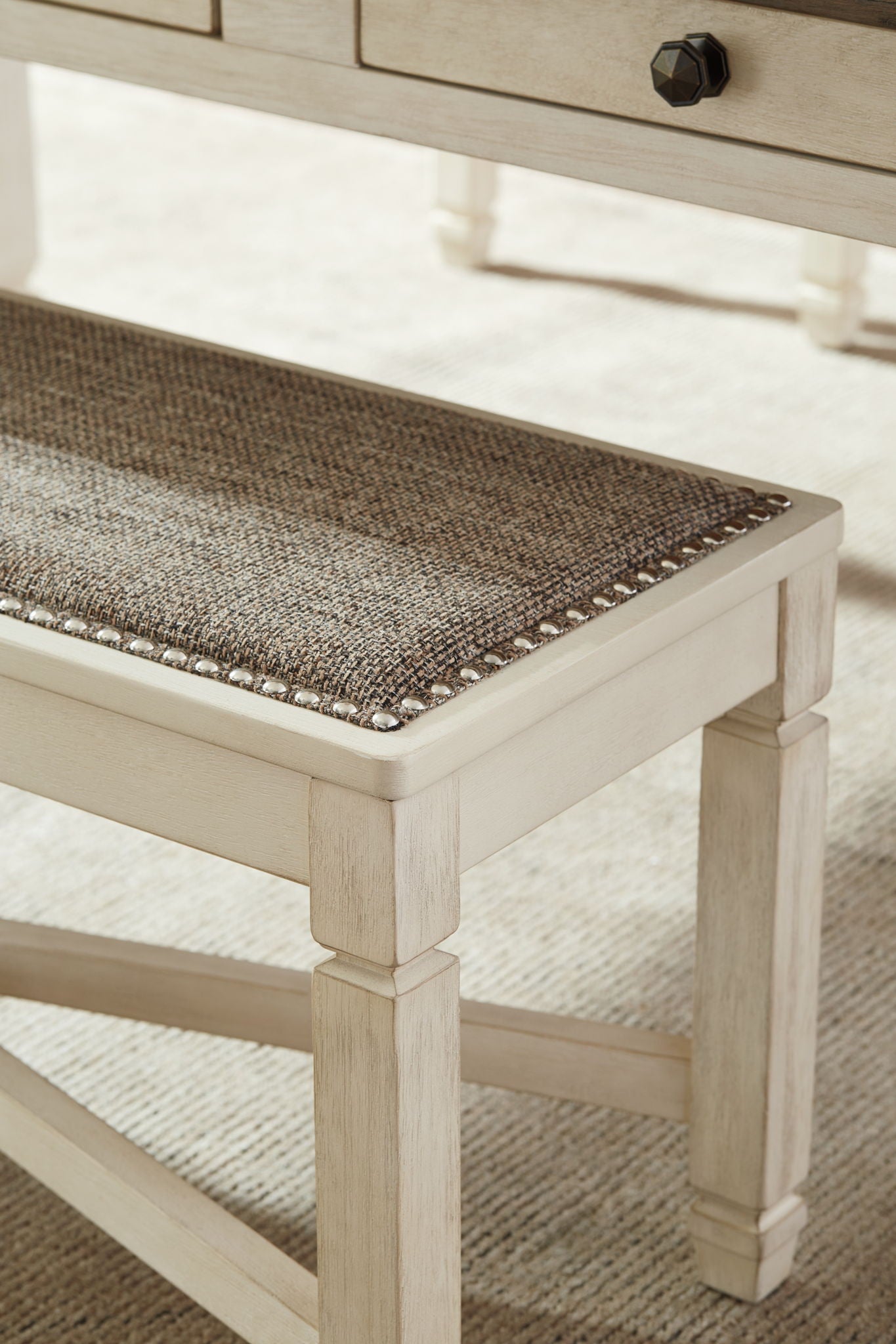 Upholstered dining bench corner view with dark brown textured seat and beige wood legs