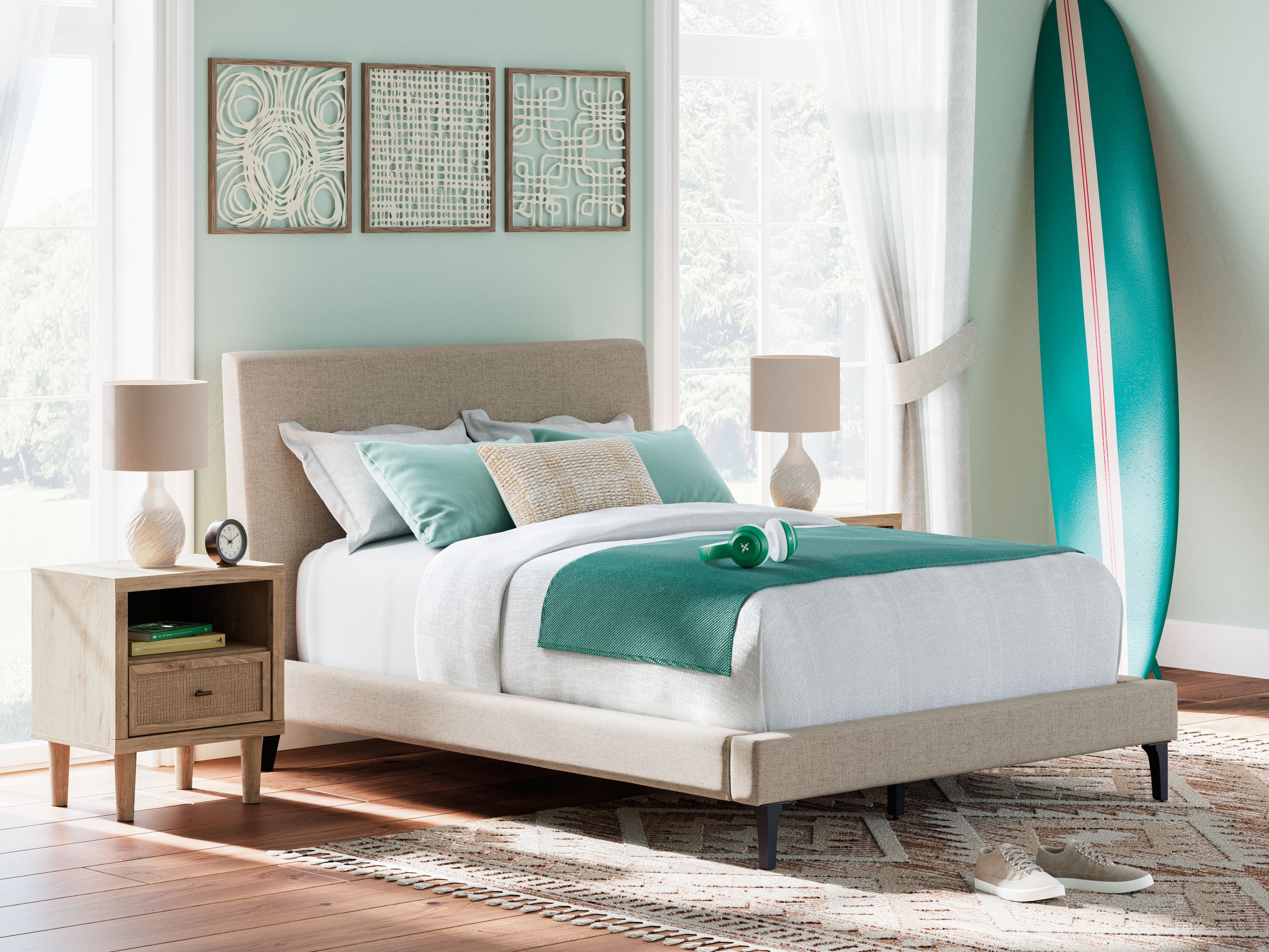 Gray upholstered bed with tall headboard and padded sides, with white mattress