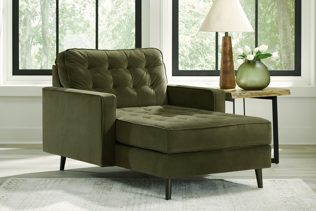 Olive upholstered chaise lounge with tufted back, wide arms, and dark legs
