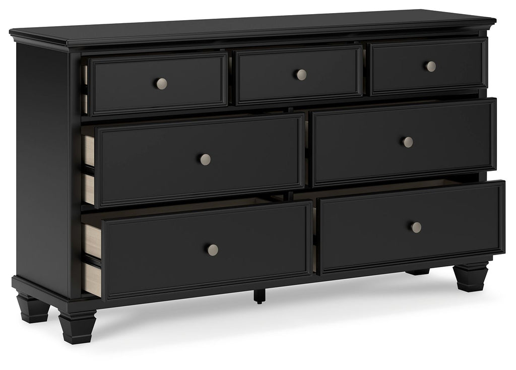 Black dresser with six drawers and round silver knobs, angled view showing side panel