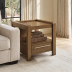 Brown square end table with top shelf, lower drawer, and metal bar pull