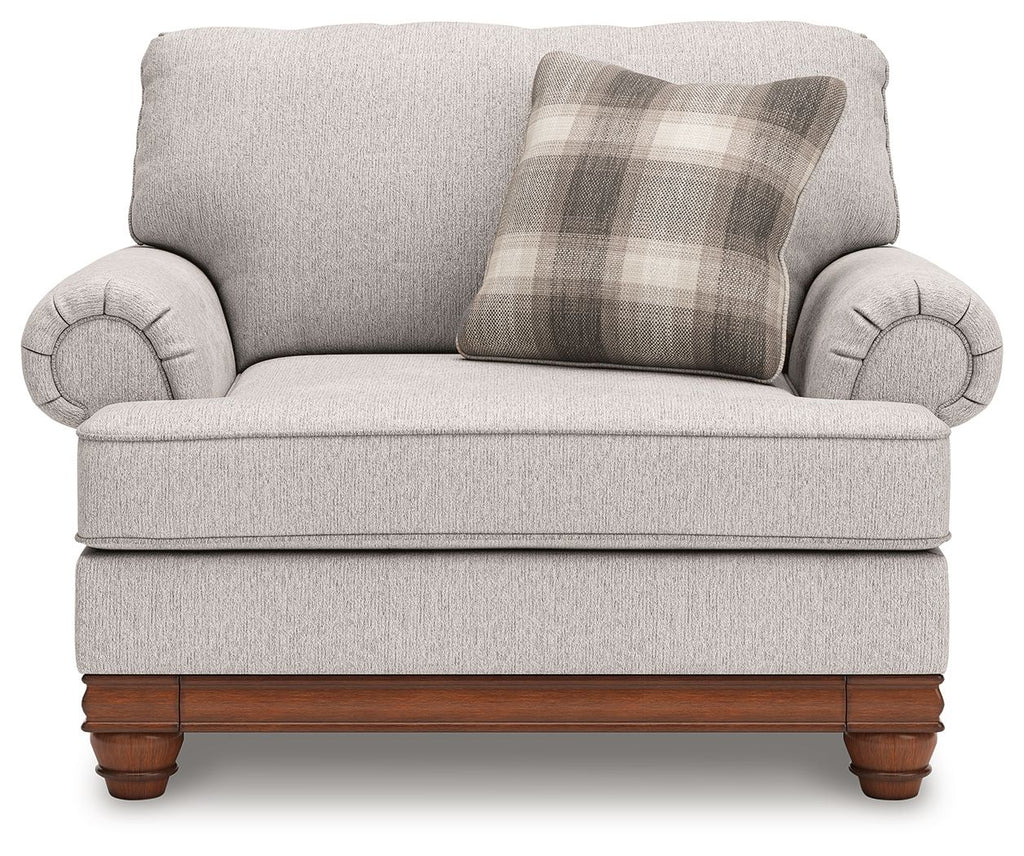 Light-gray chair and a half with plaid back pillow, rolled arms, and wood base
