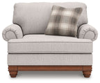 Light-gray chair and a half with plaid back pillow, rolled arms, and wood base
