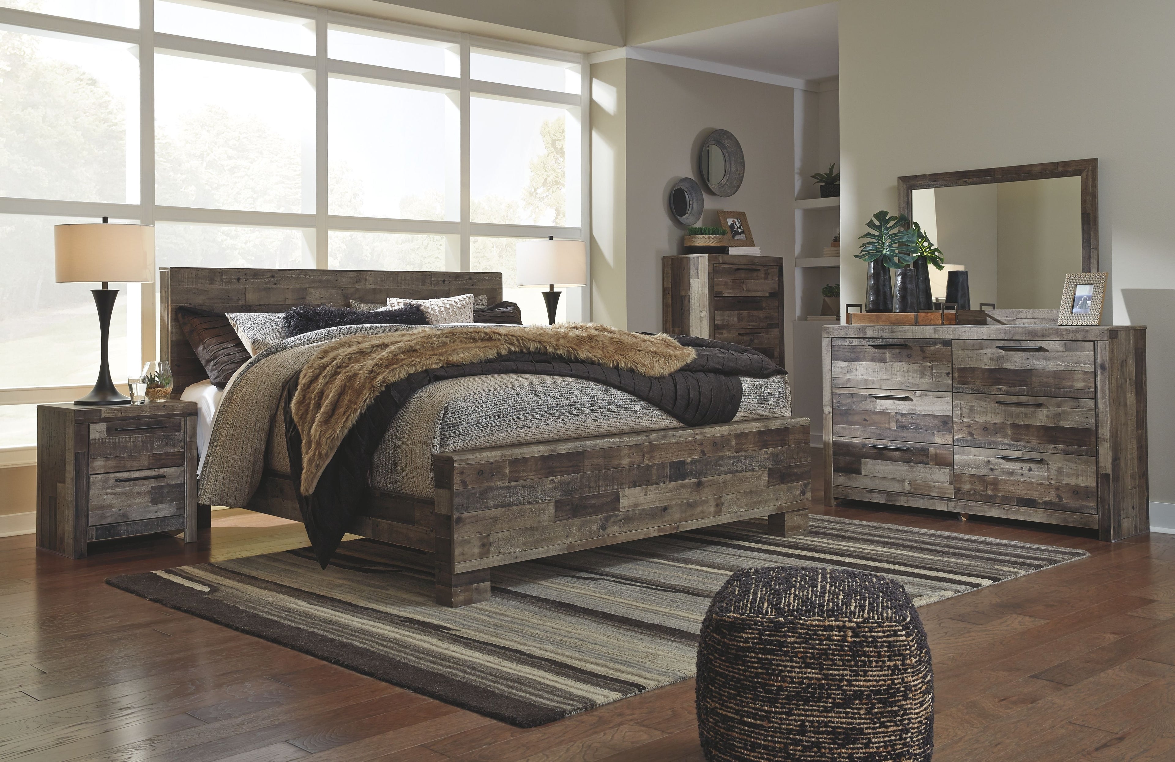 Panel bedroom set with panel bed and dresser with mirror in rustic gray wood.