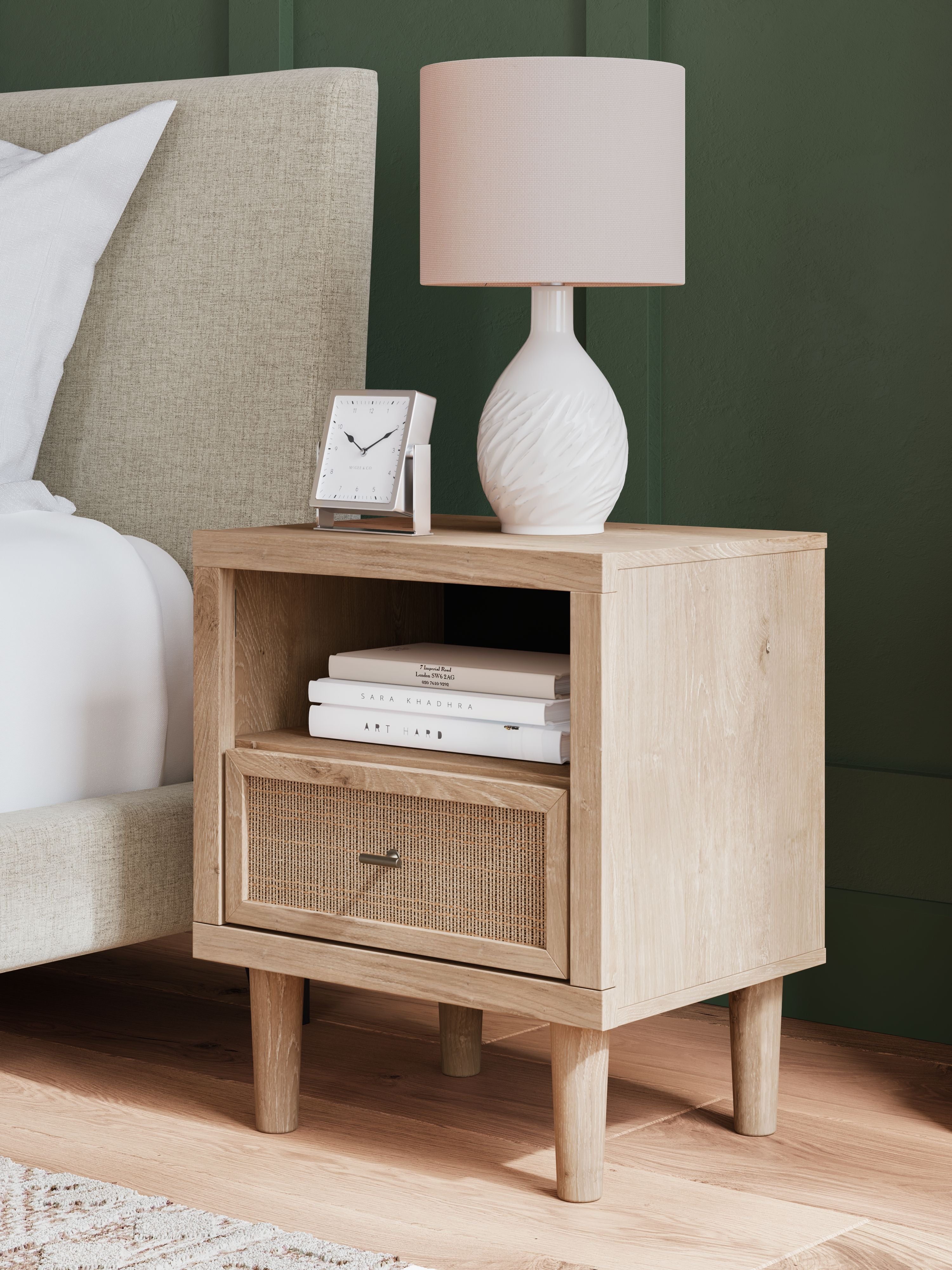 Two-tone night stand with open shelf and one woven drawer beside bed