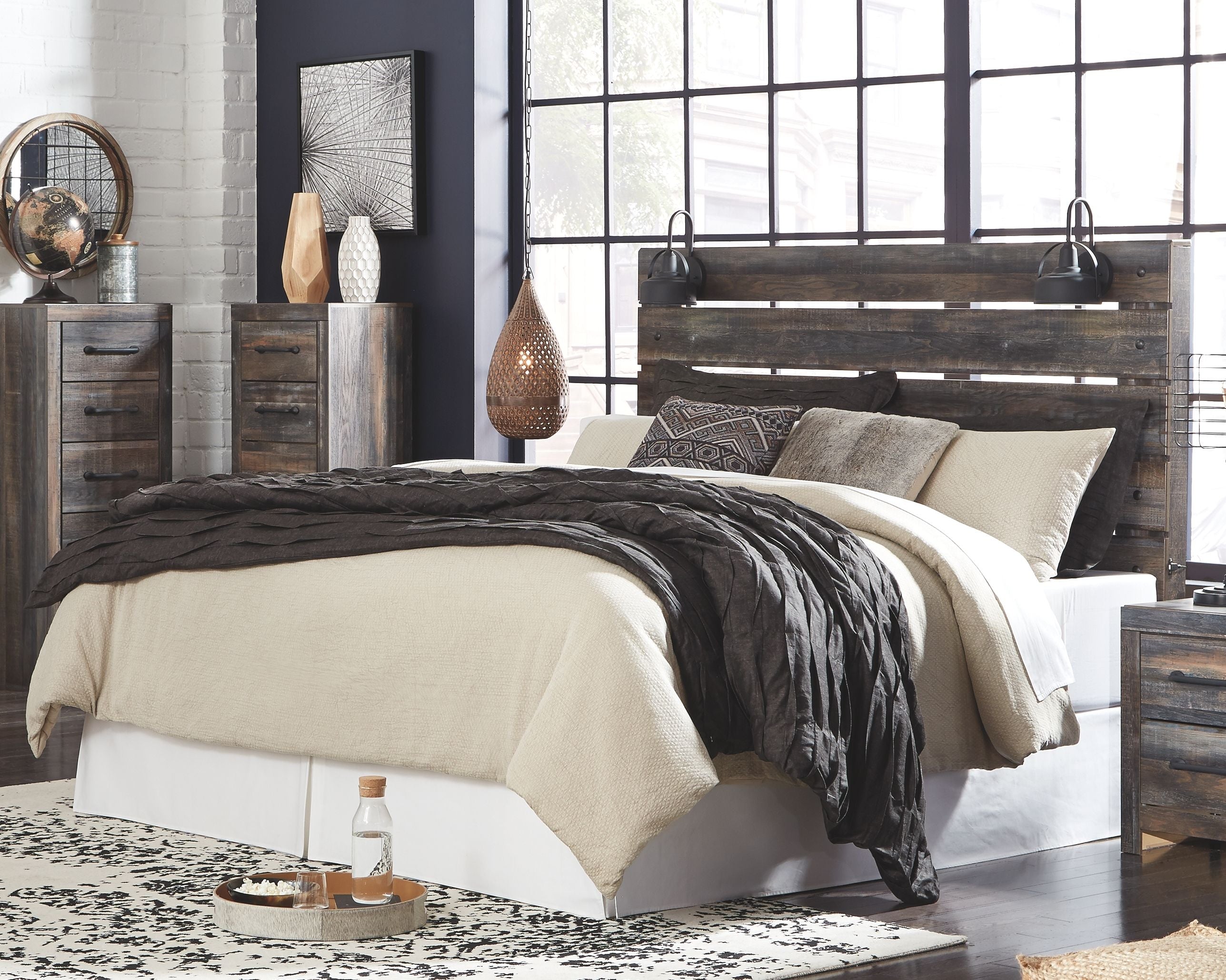 Bedroom set with dark gray panel bed, white and charcoal bedding, and matching nightstands