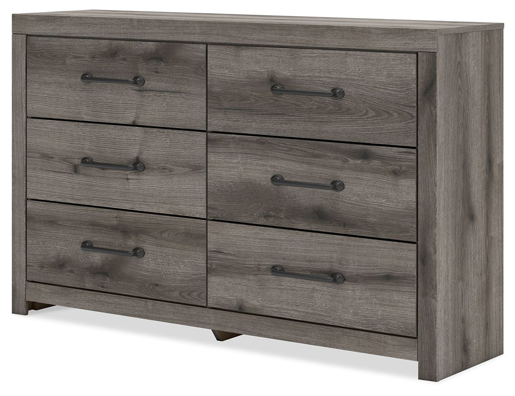 Six-drawer dresser with gray-brown wood finish and black bar handles, angled view