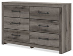 Six-drawer dresser with gray-brown wood finish and black bar handles, angled view