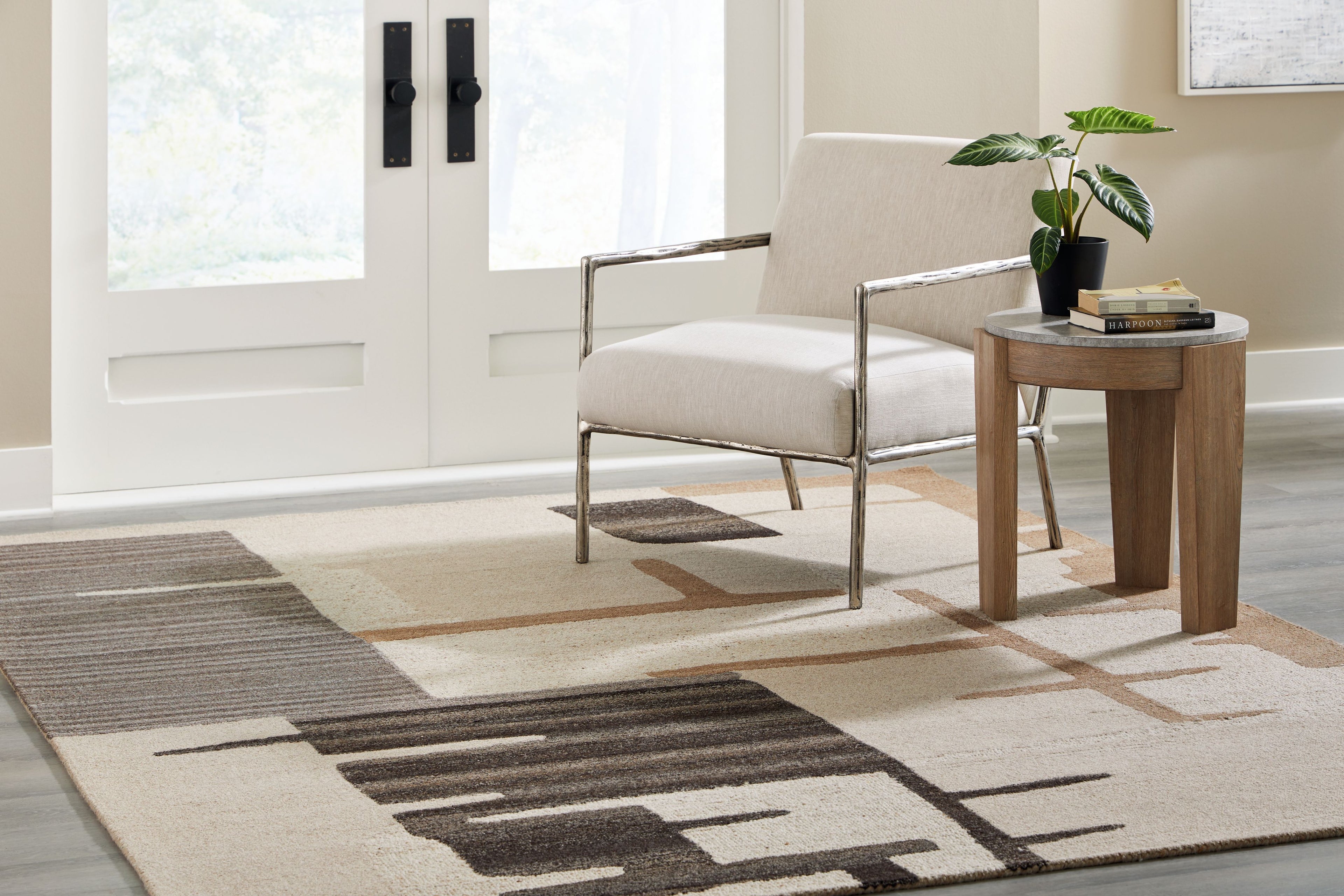 Abstract area rug with light beige base and dark brown geometric blocks