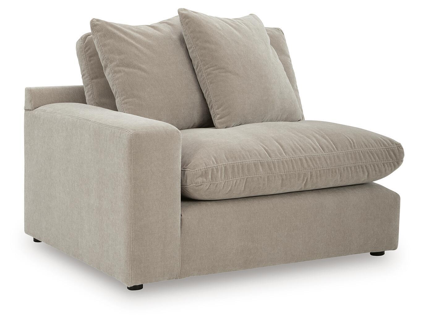 Light beige upholstered corner chair with three cushions and squared arms