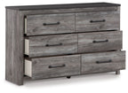 Dark gray dresser with multiple drawers, open compartments, and metal bar pulls