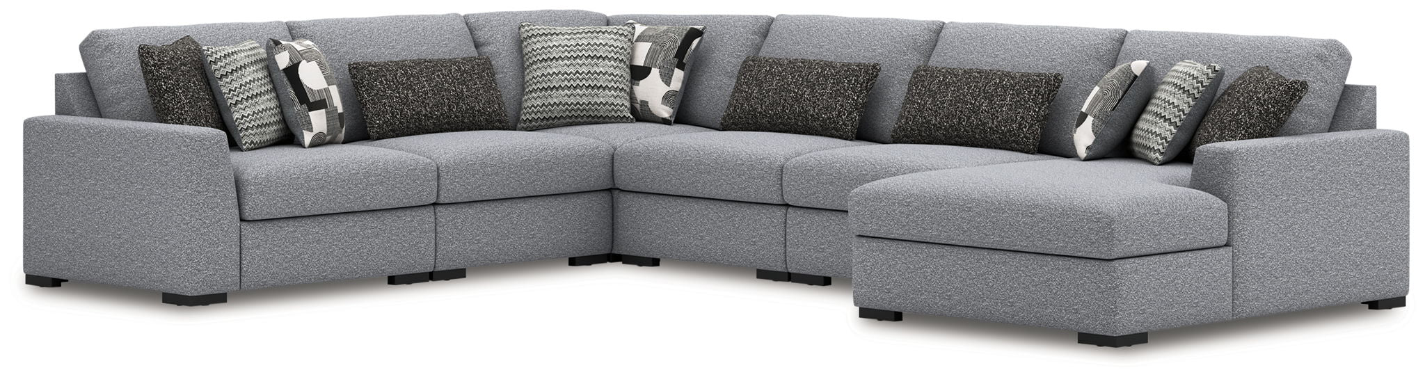 Gray fabric sectional sofa with corner layout and multiple patterned throw pillows
