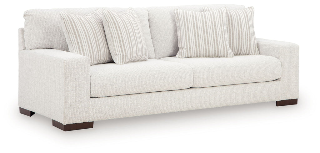 Hartside sofa with off-white fabric, striped throw pillows, two-seat design