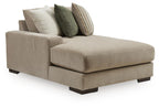 Beige corner chaise sectional with two back pillows in green and stripes