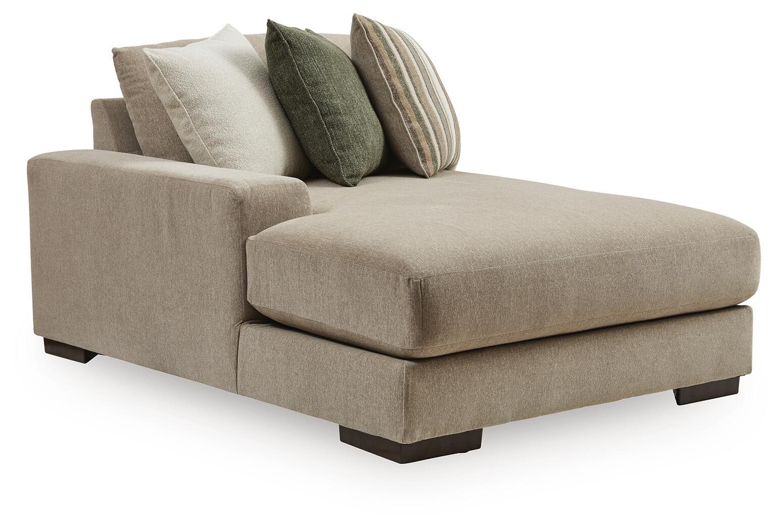 Beige corner chaise sectional with two back pillows in green and stripes
