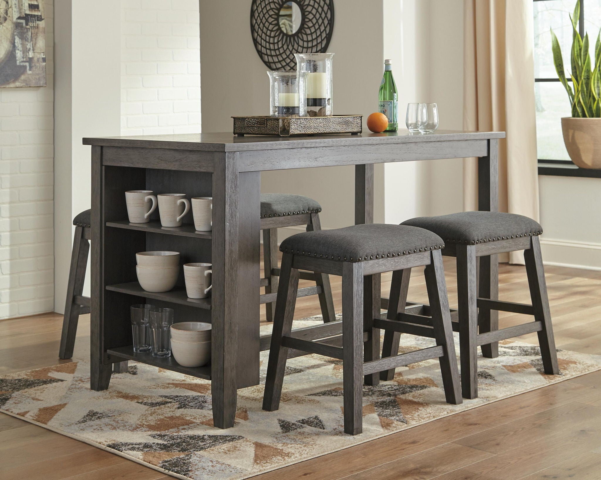 Gray rectangular dining counter table with open shelf and three upholstered bar stools