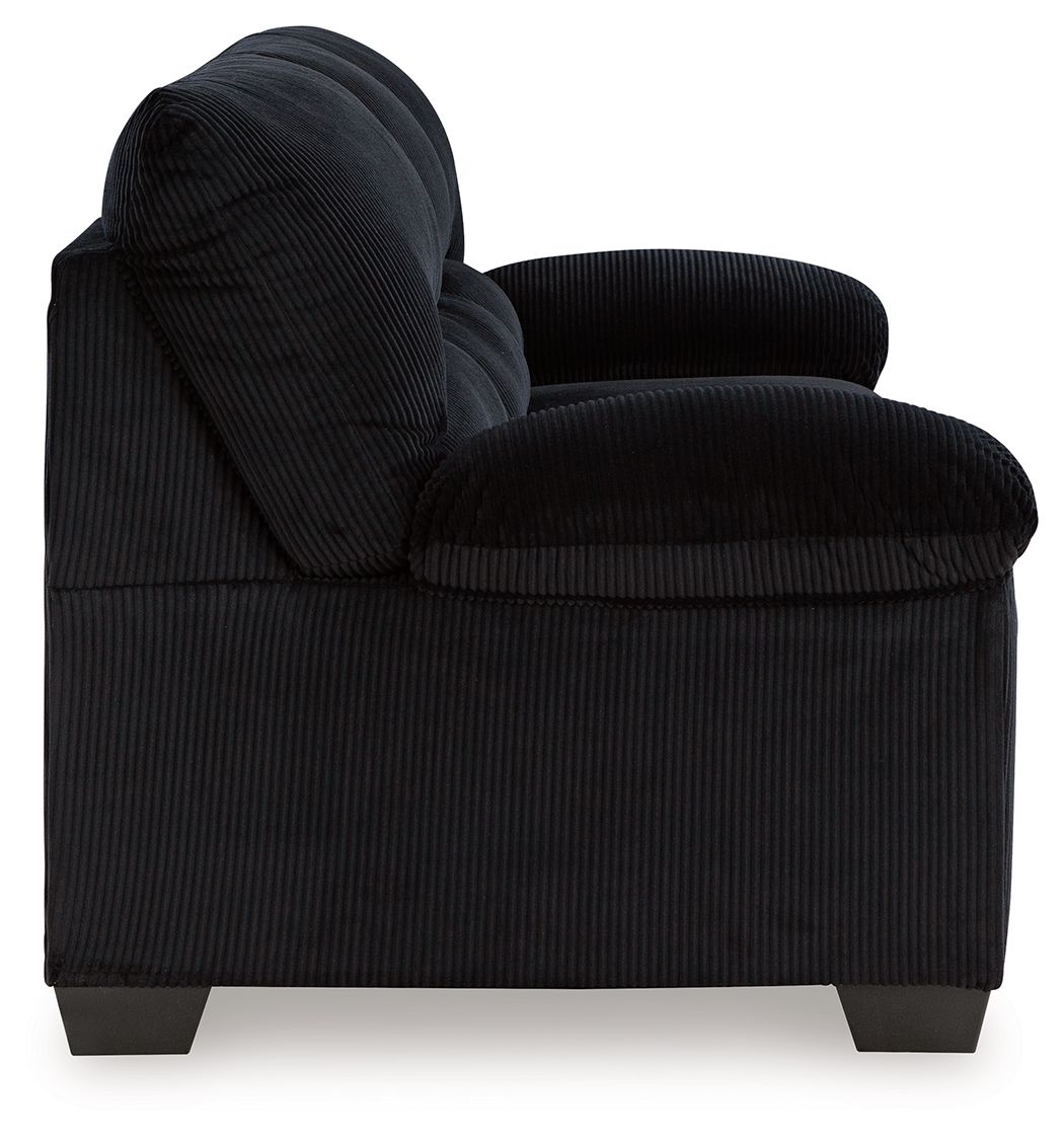 Corduroy sofa in dark navy with rolled arms and tufted back cushions