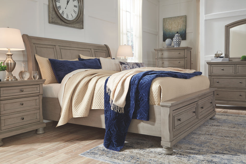 Sleigh bed with dark navy and striped blue bedding, cream sheet set