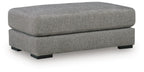 Grey upholstered oversized ottoman with wide cushioned top and tapered legs