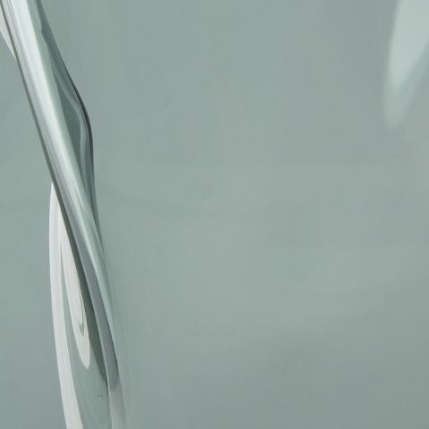 Light blue glass vase close-up of curved side wall and surface