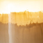 Close-up of ombre amber and ivory vase glaze with textured horizontal band