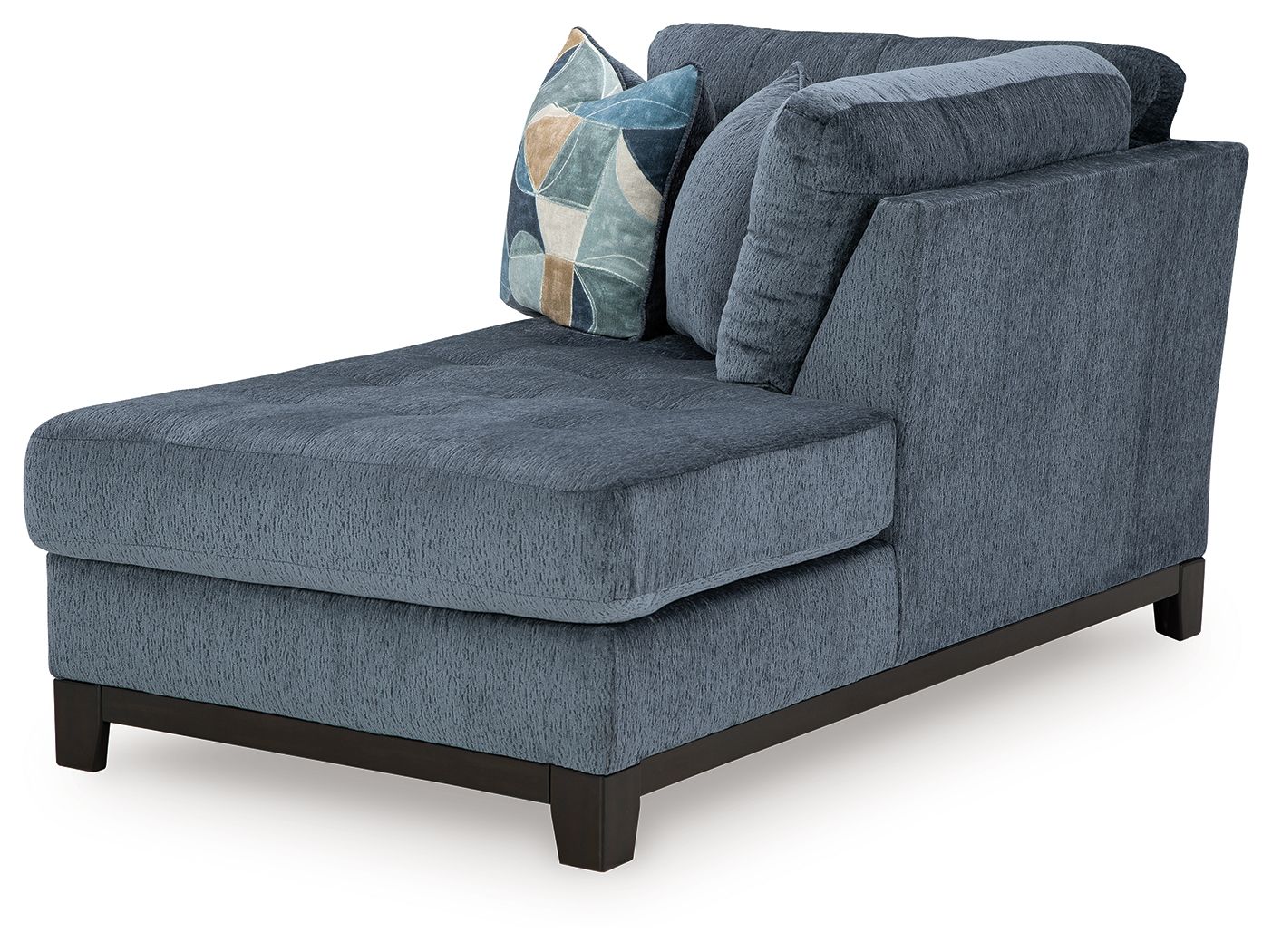 Navy chaise lounge with rounded arms, tufted back, and patterned throw pillow