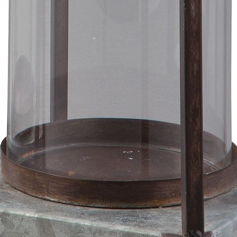 Clear glass cylinder lantern with dark metal frame and round brown base tray