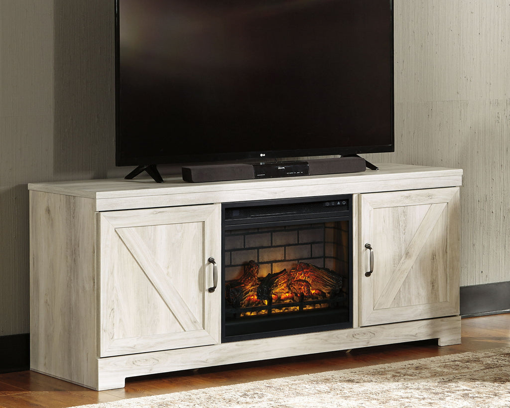 Whitewash TV stand with faux fireplace insert and TV on top, two cabinet doors