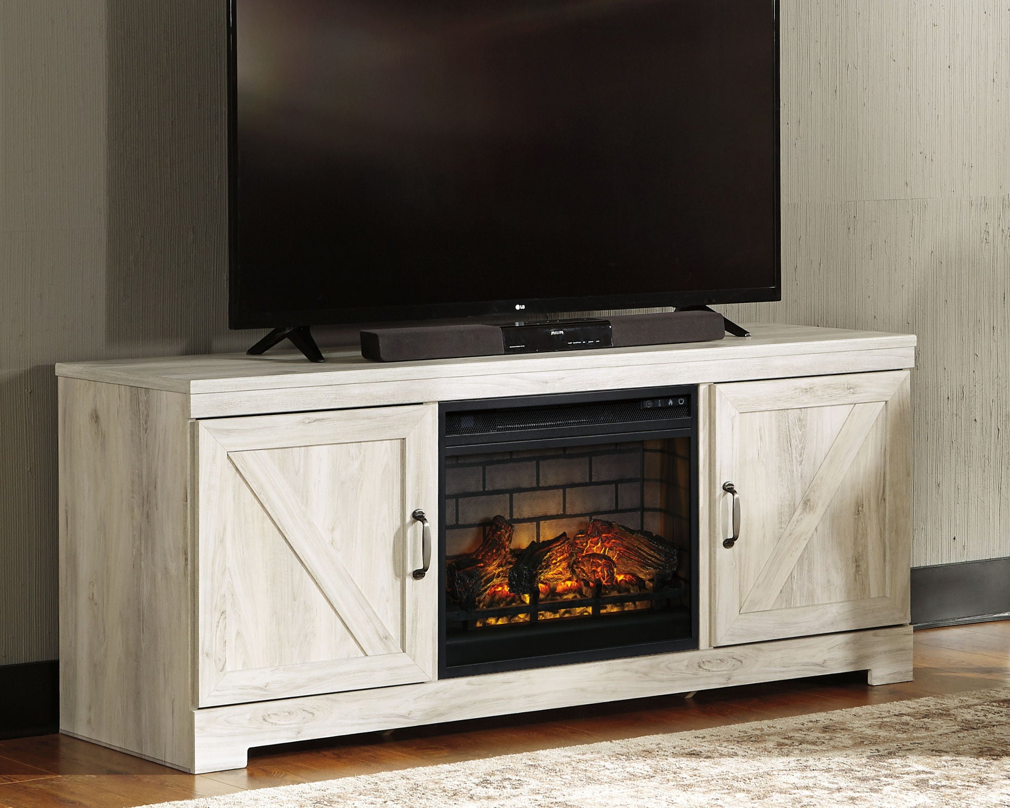 Whitewash TV stand with faux fireplace insert and TV on top, two cabinet doors
