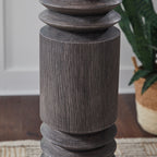 Distressed dark floor lamp column with stacked ribbed segments, close-up detail