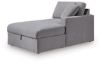 Gray corner chaise with storage and tufted cushions, with raised backrest