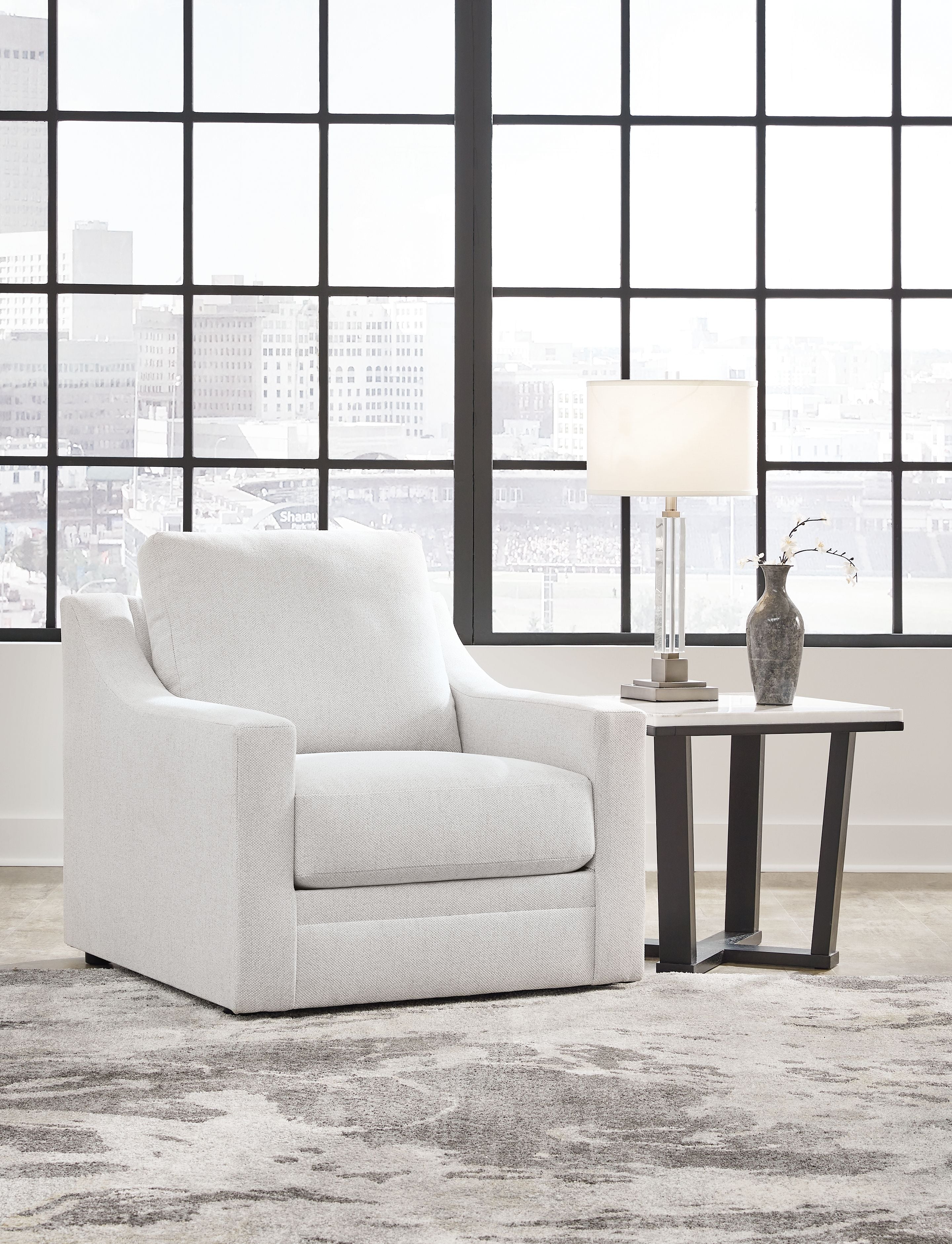 Light gray accent chair with tall back and rounded armrests